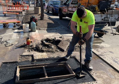 Repairing a catch basin at The Home Depot in the parking lot.