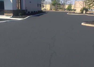 Crack sealing and sealcoating a commercial parking lot